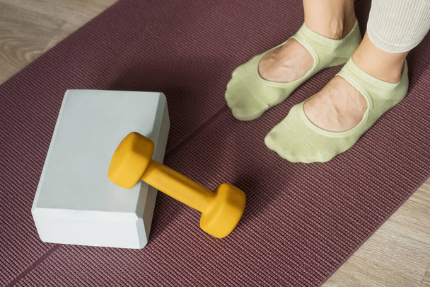 Workout and stretching accessories equipment in pilates studio. Yoga foam block, dumbbell and mat for fitness exercise. Healthy lifestyle - Fotoğraf, Görsel