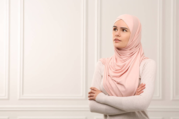 Muslim woman wearing hijab indoors, space for text - Fotó, kép