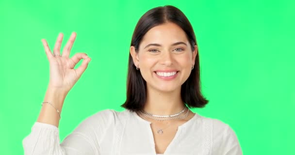Okay hands, face and happy woman on green screen, background and studio in praise of support. Portrait of female model, smile and ok for success, yes and review of perfect emoji, thank you and hope. - Footage, Video