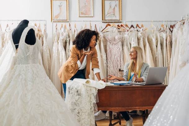 Owners of a bridal salon are discussing business - Valokuva, kuva