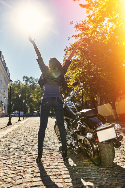 Biker girl in a leather jacket on a motorcycle - Valokuva, kuva