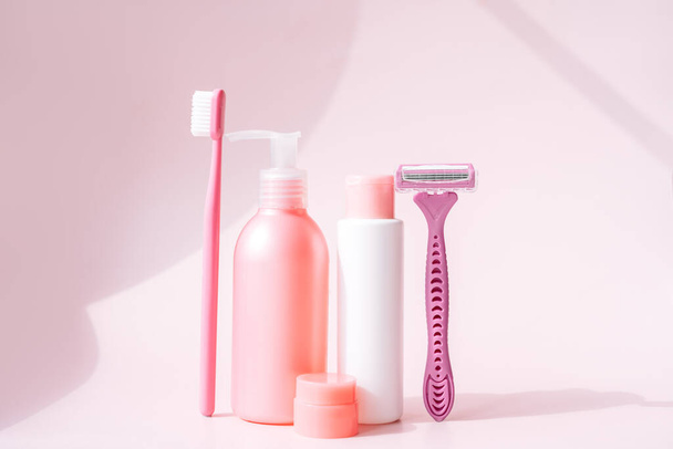 Womens hygiene and soap products in pink colors against pink background. - Фото, изображение