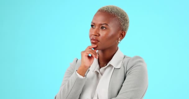 Confused, thinking and black woman in studio with decision, choice and pensive on blue background. Doubt, worry and lady shaking head, deciding or contemplating emoji while posing on isolated mockup. - Footage, Video