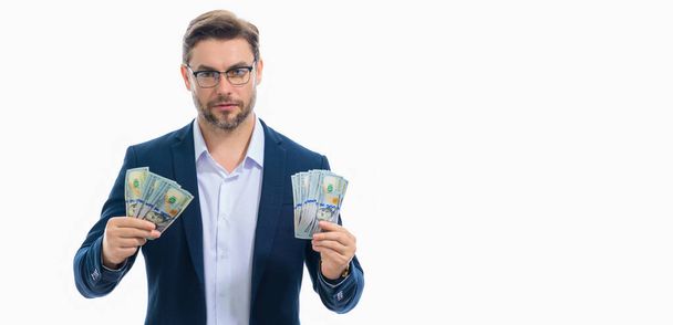 Man holding cash money in dollar banknotes on isolated white banner. Studio portrait of businessman with bunch of dollar banknotes. Dollar money concept. Career wealth business. Cash dollar banner - Foto, afbeelding