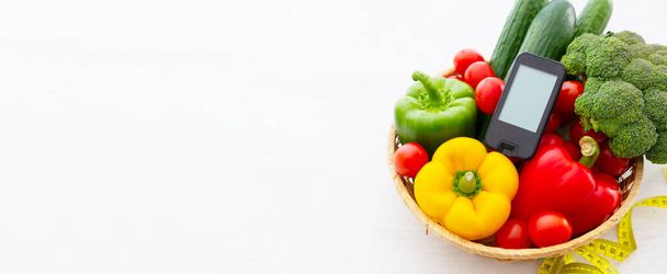 Glucometer and vegetables - healthcare, diabetes concept - Foto, Imagen