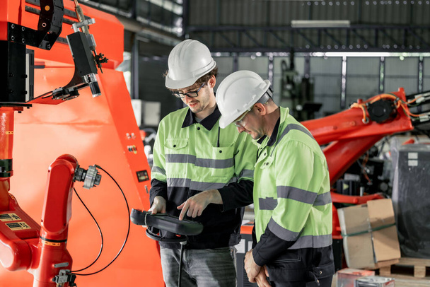 Experienced robotic technicians automate, set up, and access to a welding, lifting process via a control panel display. The production lines are repeatable, reliable, consistent, and self-checking. - Foto, afbeelding