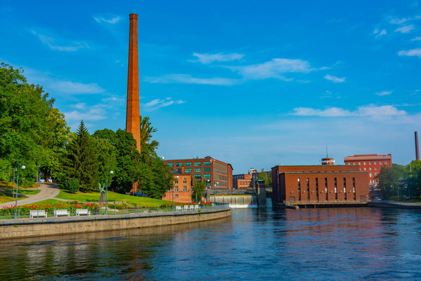 Tampere, Finland, July 22, 2022: Brick buildings alongside Tammerkoski channel in Tampere, Finland. - Photo, Image