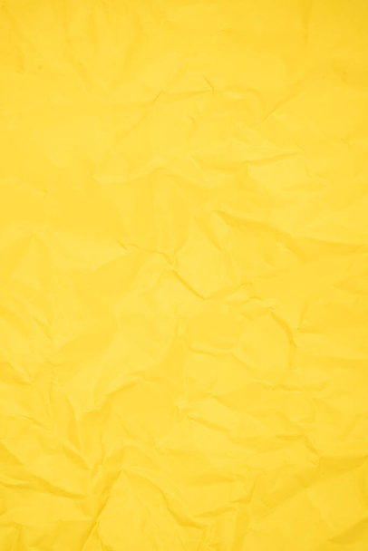 Abstract vertical yellow color creased paper texture as background. - Foto, Imagen