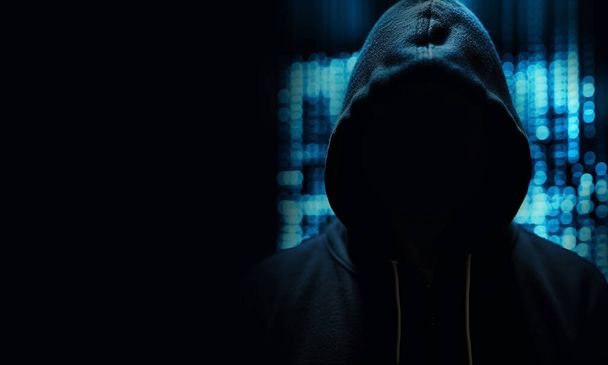 Arka planda mavi ışıklı siyah kapüşonlu bir bilgisayar korsanı, sistemdeki güvenliği aştı. Dijital hırsızların tehlikeleri, kopyalama tehlikesi olan bilinmeyen kişiler. - Fotoğraf, Görsel