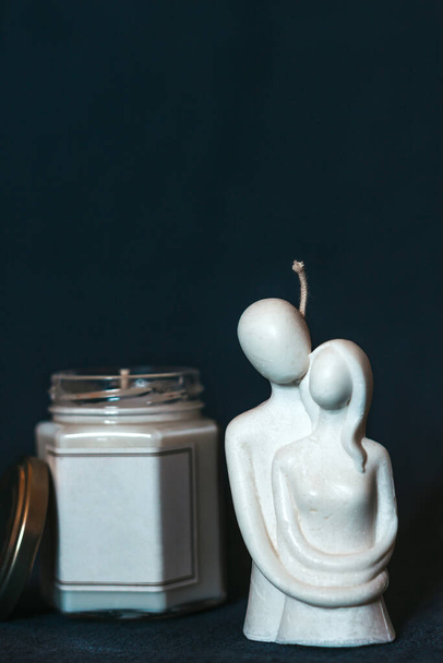 A beautiful scented candle in the shape of a couple in love. Couple in love hugging. Beautiful handmade candles. Cozy atmosphere in the house - Fotografie, Obrázek