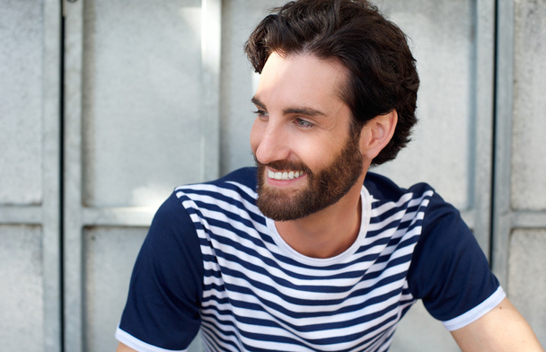 Happy man with beard and striped shirt smiling - Foto, imagen