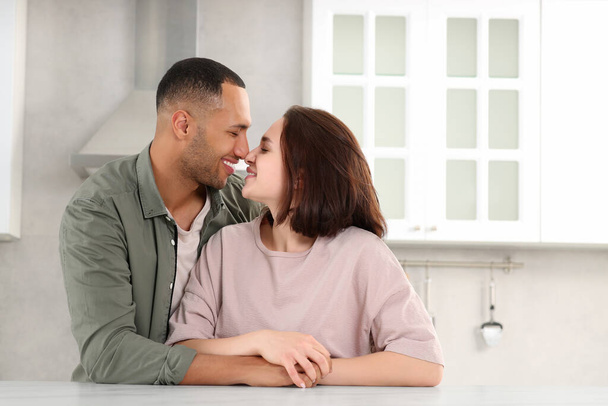 Dating agency. Happy couple spending time together in kitchen, space for text - Photo, Image