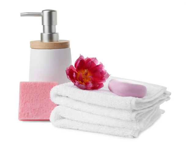 Soap bars, dispenser and stack of terry towels on white background - Fotó, kép