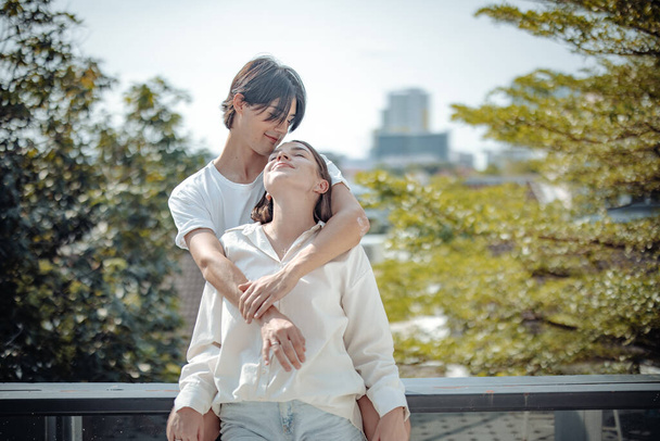 A romantic love, care, and affection of a young adult couple. Long association and mutual understanding promote the development of a warm relationship. The joyful moment of becoming life partners - 写真・画像