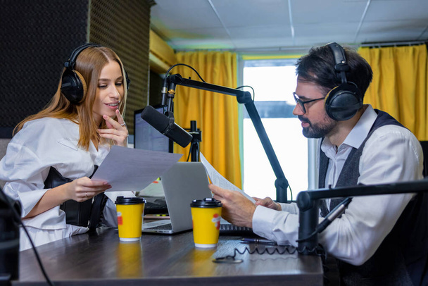 At the radio station. Radio dj talking to a guest in a radio studio - Fotó, kép