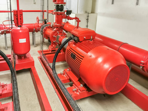 View at industrial electrically powered water pumps and pipes, this pumping group serves for water injection for building fires, sprinklers and fire reels View industrial electrically powered pump... - Photo, Image