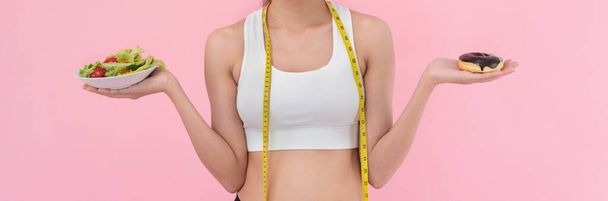 slim body Women choose during healthy foods and junk food, female choose salad for diet. Good healthy food. weight lose, balance, control, reduce fat, low calories, routines, exercise. - 写真・画像
