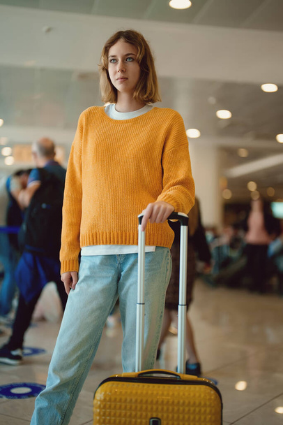 Teenage girl with luggage in airport. - Valokuva, kuva