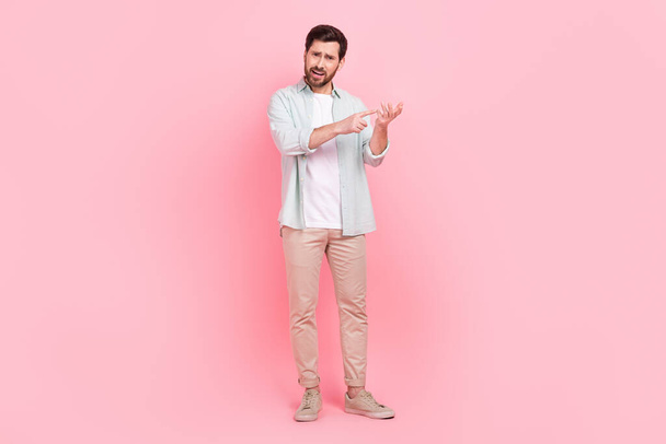 Full length photo of nice young male counting fingers match explain irritated wear trendy blue garment isolated on pink color background. - Photo, Image