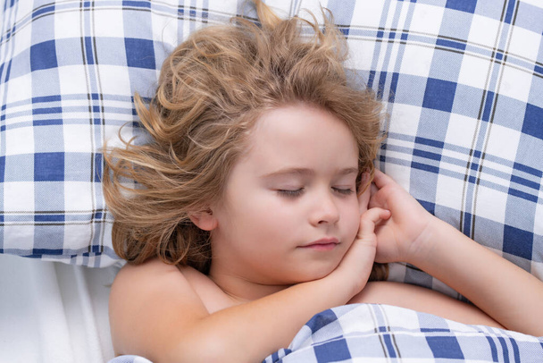 Quiet sleep. Kid sleeping in bed. Child sleeping in bed under blanket. Kid lying on pillow, child rest asleep, enjoy healthy sleep or nap - Photo, image