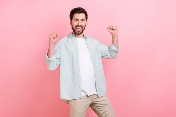 Photo portrait of attractive young man raise fists celebrate success lottery wear trendy blue outfit isolated on pink color background. - Valokuva, kuva