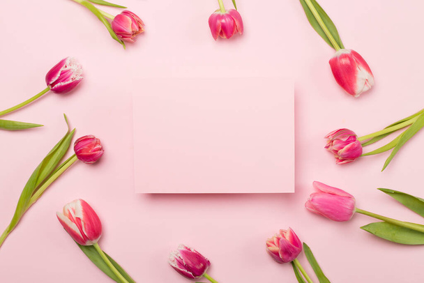 Bright tulips on color background, top view. Greeting card mockup - 写真・画像