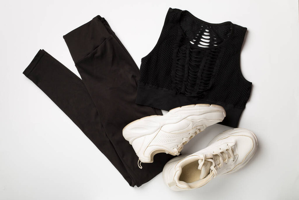 Flat lay composition with sport clothes on white background, top view. - Photo, Image