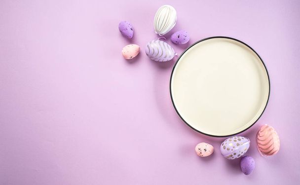 Easter eggs on plate purple background. Happy Easter holiday concept. - Photo, Image