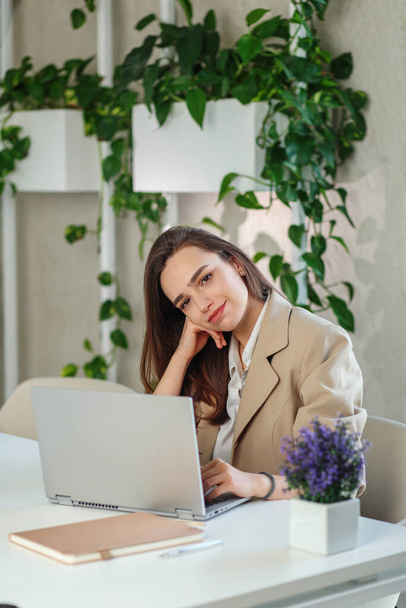 Woman is working job on laptop computer in modern office. Doing accounting analysis report real estate investment data, financial and tax systems concept - Foto, imagen