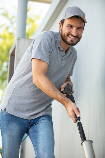 one adult man is hoovering smiling to the camera - Φωτογραφία, εικόνα