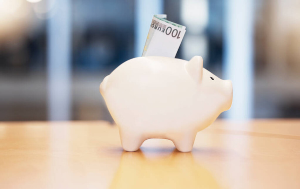 Saving, money and piggybank on a table for finance, budget and investment. Security, dollar and a tool for savings, cash safety and financial growth at a company for banking and pension wealth. - Photo, Image