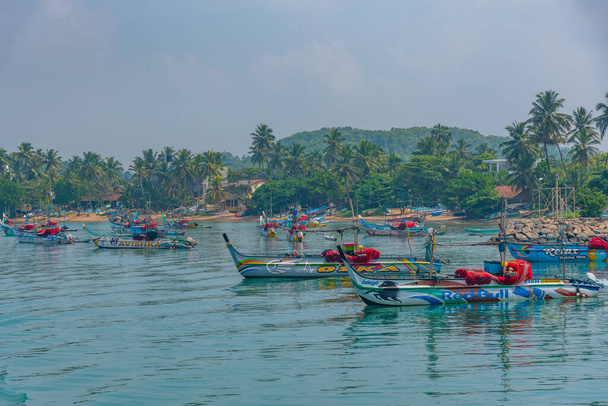 Mirissa, Sri Lanka, January 23, 2022: Fishing boats at the port of Mirissa, Sri Lanka. - Fotoğraf, Görsel