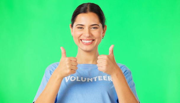 Happy woman, volunteer and hands in thumbs up on green screen for agreement or success against a studio background. Portrait of female showing thumb emoji, yes sign or like for good job on mockup. - Φωτογραφία, εικόνα