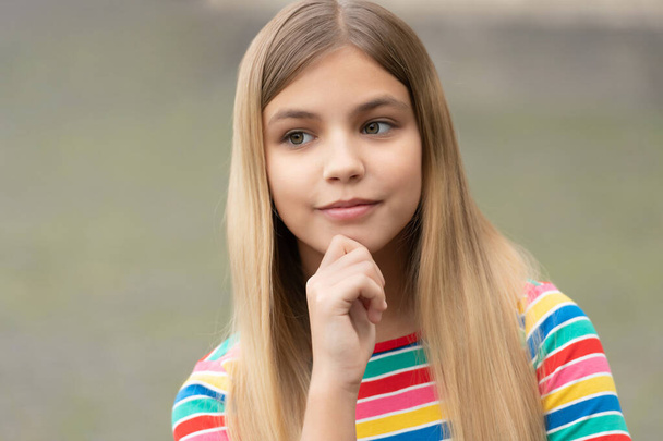 portrait of thoughtful teen girl with blonde hair. portrait of teen girl outdoor. portrait photo of teen girl outside. portrait of teen girl. - Фото, зображення