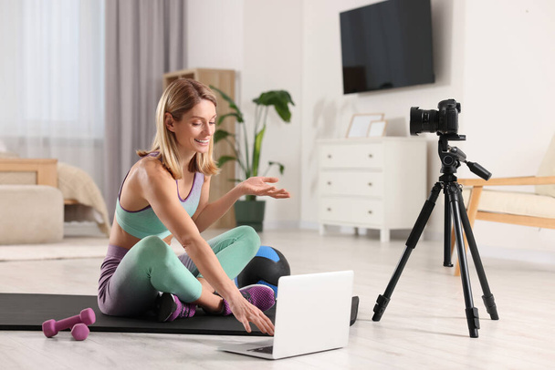 Fitness trainer recording online classes at home - 写真・画像
