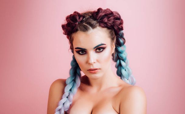 Brunette girl with perfect make up. Beautiful woman with braided hairstyle. Care and beauty braid hair products. Lady with braided hair. Model with jewelry. Turquoise background. - Φωτογραφία, εικόνα