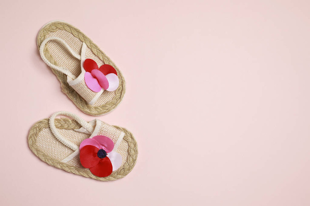Cute baby shoes on beige background, flat lay. Space for text - Φωτογραφία, εικόνα
