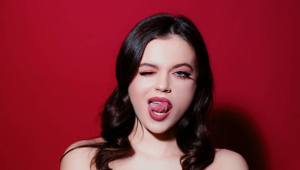 Naughty girl showing tongue. Girl sticking out tongue. People emotions and feelings. Seductive desire - Valokuva, kuva