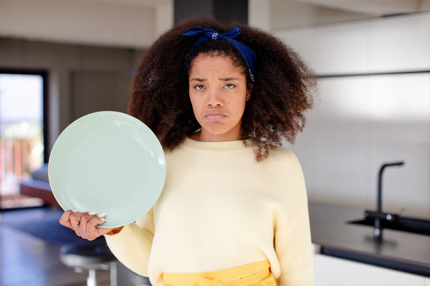 pretty afro black woman feeling sad and whiney with an unhappy look and crying. home chef concept - Photo, Image