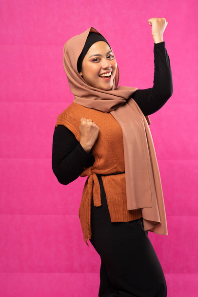 Excited Asian Muslim woman in hijab standing with isolated background - Foto, Imagem