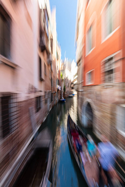Gondolier rowing gondola on scenic canal in Venice, Italy. Motion blur - Foto, Imagem