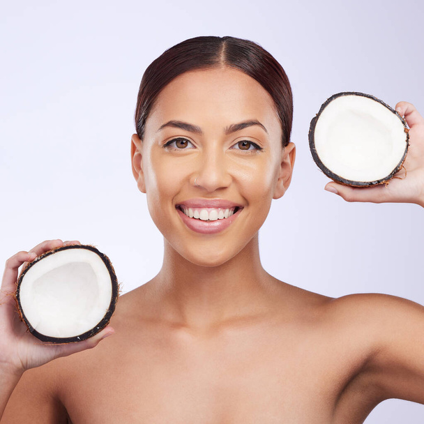 Woman, coconut and studio portrait with smile for self care, skincare or beauty with natural benefits for face. Girl, model and fruit for skin wellness, cosmetic health and dermatology by background. - Zdjęcie, obraz