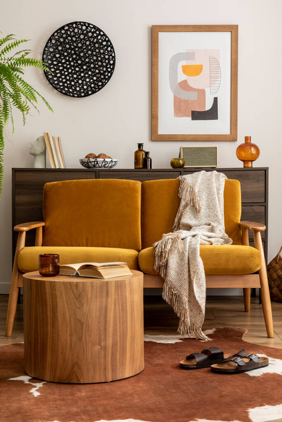 Vintage retro composition of living room interior with mock up poster frame, yellow velur sofa, plants, wooden commode, coffee table and personal accessories. Stylish home decor. Template. - Foto, Bild