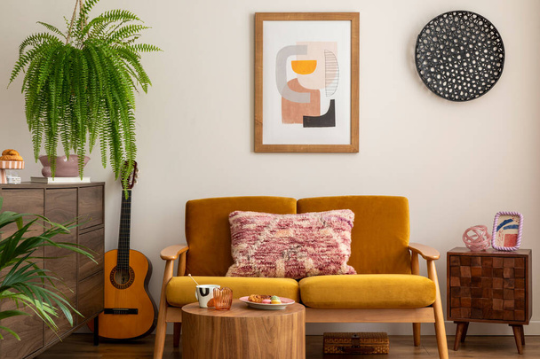 Vintage and cozy space of dining room with mock up poster frame, yellow sofa, wooden coffee table, guitar, plants, commode, decoration and personal accessories. Stylish home decor. Template. - 写真・画像