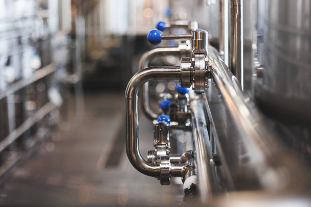 Beer brewing . Commercial brewing equipment close up shot. Industrial beer brewing stainless pipe - Foto, immagini