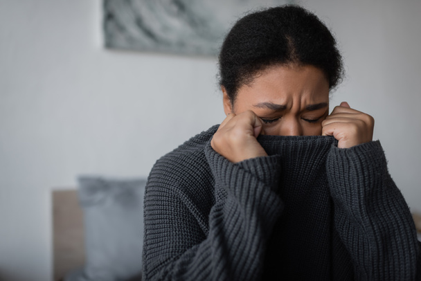 multiracial woman with mental problem crying in bedroom at home  - Foto, Imagem