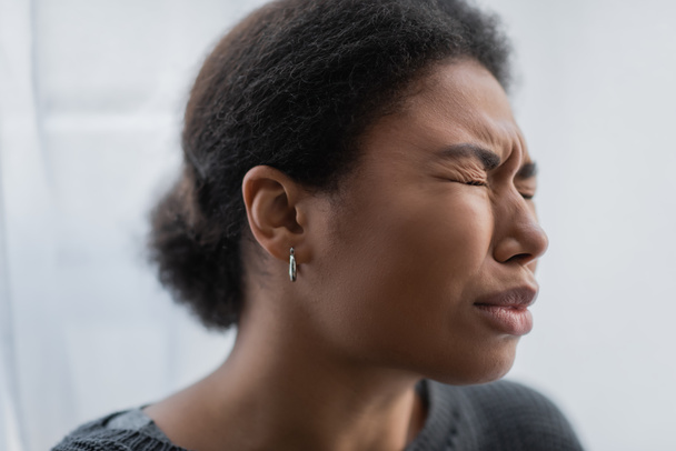 Sad multiracial woman with psychological crisis crying at home  - Photo, image
