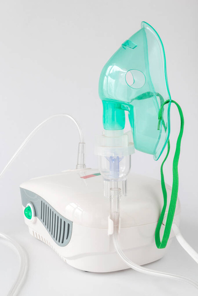 Medical equipment for inhalation with a respiratory mask nebulizer on a white background - Foto, Imagem