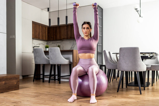 Fitness femme faisant haltère séance d'entraînement à la maison. - Photo, image