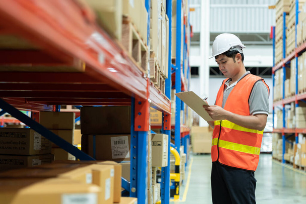 Asian male factory manager inspect goods in warehouse or inventory and check stock product. Transport logistic business shipping, delivery to customers. inspection, storehouse, storage, factory - 写真・画像